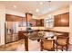 Well-lit kitchen features an island, stainless steel appliances, and dark cabinetry at 16459 W 86Th Pl # B, Arvada, CO 80007