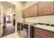 Modern laundry room with stainless steel washer and dryer and ample cabinet space at 16459 W 86Th Pl # B, Arvada, CO 80007