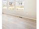Bright, open living room featuring light vinyl floors, white walls, and several windows providing lots of light at 22485 E 7Th Pl, Aurora, CO 80018