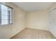 A cozy carpeted bedroom featuring a bright window and a closet at 8418 Everett Way # C, Arvada, CO 80005
