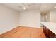 Bedroom featuring hardwood floors, ceiling fan and convenient bar area with counter at 8418 Everett Way # C, Arvada, CO 80005