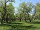 A large, lush community park featuring mature trees and open green space at 8418 Everett Way # C, Arvada, CO 80005