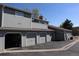 Exterior view of a multi-unit home with garages and neutral siding at 8418 Everett Way # C, Arvada, CO 80005