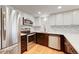 Modern kitchen featuring stainless steel appliances, quartz countertops, and wood floors at 8418 Everett Way # C, Arvada, CO 80005