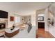 Bright living room boasts fireplace, wood floors, and seamless flow into dining area at 8418 Everett Way # C, Arvada, CO 80005