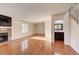 Bright living room featuring hardwood floors, fireplace, and half bathroom with stylish vanity and modern fixtures at 8418 Everett Way # C, Arvada, CO 80005