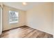 Bedroom featuring hardwood floors and a large window at 16755 E Union Ave, Aurora, CO 80015