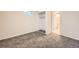 Bedroom with neutral walls, carpet, closet and bathroom access at 16755 E Union Ave, Aurora, CO 80015