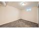 Simple bedroom with neutral walls, gray carpet, and standard electrical outlets at 16755 E Union Ave, Aurora, CO 80015