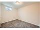 Cozy bedroom featuring neutral walls, gray carpet, and a window for natural light at 16755 E Union Ave, Aurora, CO 80015