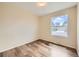 Bedroom featuring hardwood floors and a large window at 16755 E Union Ave, Aurora, CO 80015