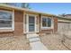 Close-up of a brick house with well-maintained front yard and easy access to the front door at 16755 E Union Ave, Aurora, CO 80015