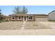 Charming brick home featuring a well-kept front yard with easy access to the garage at 16755 E Union Ave, Aurora, CO 80015