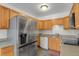Well-lit kitchen featuring stainless steel appliances and ample cabinet space at 2103 Coronado N. Pkwy # D, Denver, CO 80229