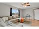 Bright living room with a sectional sofa, area rug, and a view of the outdoors at 2103 Coronado N. Pkwy # D, Denver, CO 80229