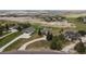 Picturesque aerial view of homes in a green landscape with winding roads and mountain backdrop at 937 Caribou Dr, Monument, CO 80132