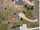 A bird's eye view of the property with an elongated driveway and a wooden deck at 937 Caribou Dr, Monument, CO 80132