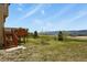 Beautiful view from the property's backyard, featuring a wooden deck with stairs at 937 Caribou Dr, Monument, CO 80132