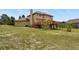 Spacious backyard with a deck and lush green grass, perfect for outdoor entertaining at 937 Caribou Dr, Monument, CO 80132