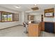 Carpeted basement featuring a bar area with a bar stool, microwave, and under-counter refrigerator at 937 Caribou Dr, Monument, CO 80132