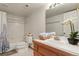 Bright bathroom with a tub and shower combination and white tile backsplash at 937 Caribou Dr, Monument, CO 80132