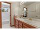 Bathroom featuring double sinks, tile countertop, and a separate bath and shower at 937 Caribou Dr, Monument, CO 80132