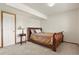 Bedroom with carpet, wood trim, and a bed with a decorative headboard and patterned bedding at 937 Caribou Dr, Monument, CO 80132