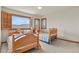 Bedroom featuring two twin beds, shuttered windows with mountain views, and carpeted flooring at 937 Caribou Dr, Monument, CO 80132