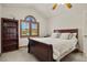 This bedroom has a vaulted ceiling, a decorative window, carpet, and a dark wood bookcase at 937 Caribou Dr, Monument, CO 80132