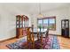 Elegant dining room with hardwood floors, display cabinet, and mountain views at 937 Caribou Dr, Monument, CO 80132
