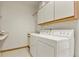 Laundry room with washer, dryer, cabinets, and utility sink at 937 Caribou Dr, Monument, CO 80132