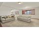 Basement living room featuring two white sofas, carpeted floor, and natural light at 937 Caribou Dr, Monument, CO 80132