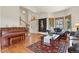 Sunlit entry with a piano, plush seating, and classic rug offers a comfortable and elegant space at 937 Caribou Dr, Monument, CO 80132