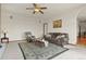 Cozy living room featuring a plush leather sofa, rocking chair, and area rug at 937 Caribou Dr, Monument, CO 80132