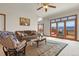 Bright living room boasts a leather sofa, area rug, and sliding glass doors to an outdoor deck at 937 Caribou Dr, Monument, CO 80132