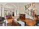 Open concept living room featuring hardwood floors, an area for piano, and a staircase at 937 Caribou Dr, Monument, CO 80132