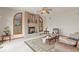 Cozy living room with brick fireplace, ceiling fan, and plush seating arrangements at 937 Caribou Dr, Monument, CO 80132