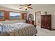 Main bedroom with hardwood furniture, ceiling fan, and picturesque mountain views at 937 Caribou Dr, Monument, CO 80132