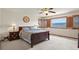 Main bedroom with ceiling fan, hardwood furniture, and a picturesque view at 937 Caribou Dr, Monument, CO 80132