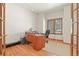 Bright office space with hardwood floors and a window with wood shutter blinds at 937 Caribou Dr, Monument, CO 80132