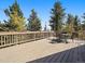 Spacious deck with mountain views, seating, and a grill at 513 Hyland Dr, Evergreen, CO 80439