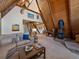 Living room with vaulted wood ceilings, a fireplace, and ample seating at 513 Hyland Dr, Evergreen, CO 80439