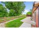 Backyard view showcasing a spacious patio, a lush lawn, and a serene setting at 5577 Jasper St, Denver, CO 80239
