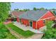 Charming backyard with a spacious patio, a lush lawn, and mature trees offering shade at 5577 Jasper St, Denver, CO 80239