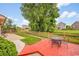 Inviting backyard featuring a red stamped concrete patio and a lush green lawn, perfect for relaxation and outdoor activities at 5577 Jasper St, Denver, CO 80239