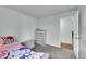 Bedroom featuring carpeted floor and a stylish dresser with view to open doorway at 5577 Jasper St, Denver, CO 80239