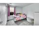 Cozy bedroom features a window letting in natural light, carpeted floor, and playful Hello Kitty bedding at 5577 Jasper St, Denver, CO 80239