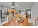 Open-concept kitchen with stainless steel refrigerator, wooden cabinets, and dining table seating for six at 5577 Jasper St, Denver, CO 80239