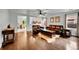 An open-concept living room shows the hardwood floors, leather furniture, and connections to other spaces at 5577 Jasper St, Denver, CO 80239