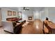 Spacious living room with hardwood floors, fireplace, ceiling fan, and leather furniture at 5577 Jasper St, Denver, CO 80239